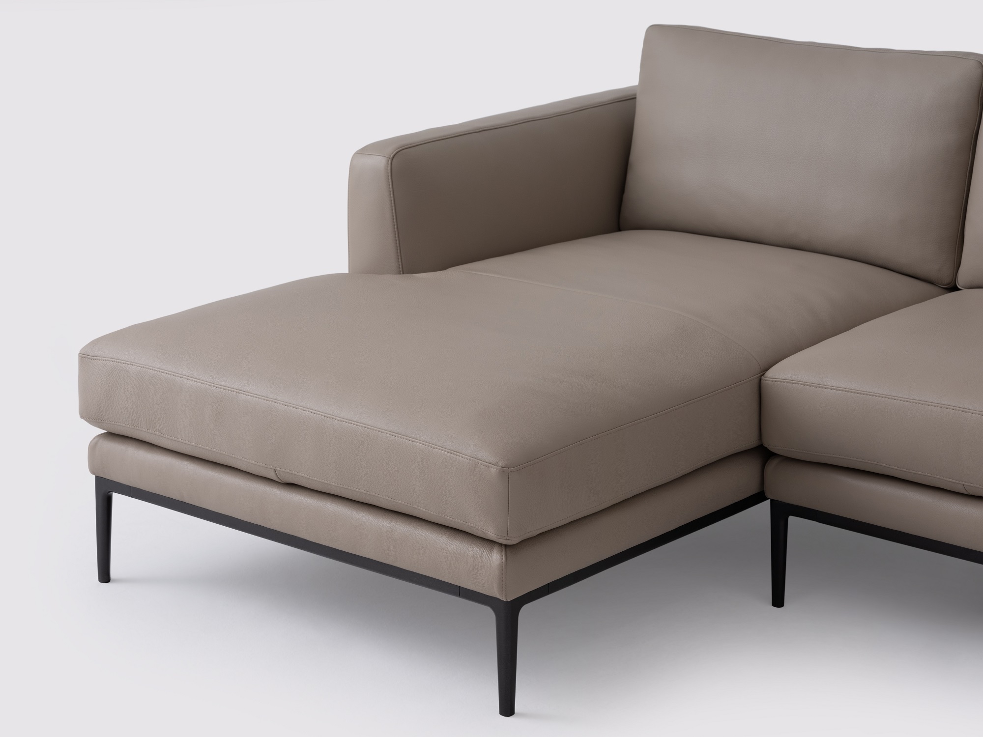 Detail chaise view of the Oma modern sectional couch in grey leather